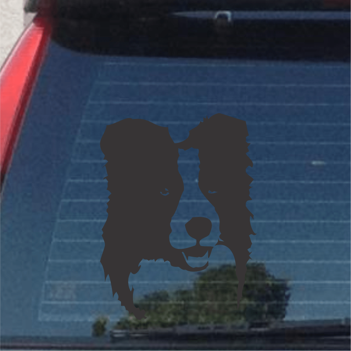 Dog decal on a car window with a blurred background