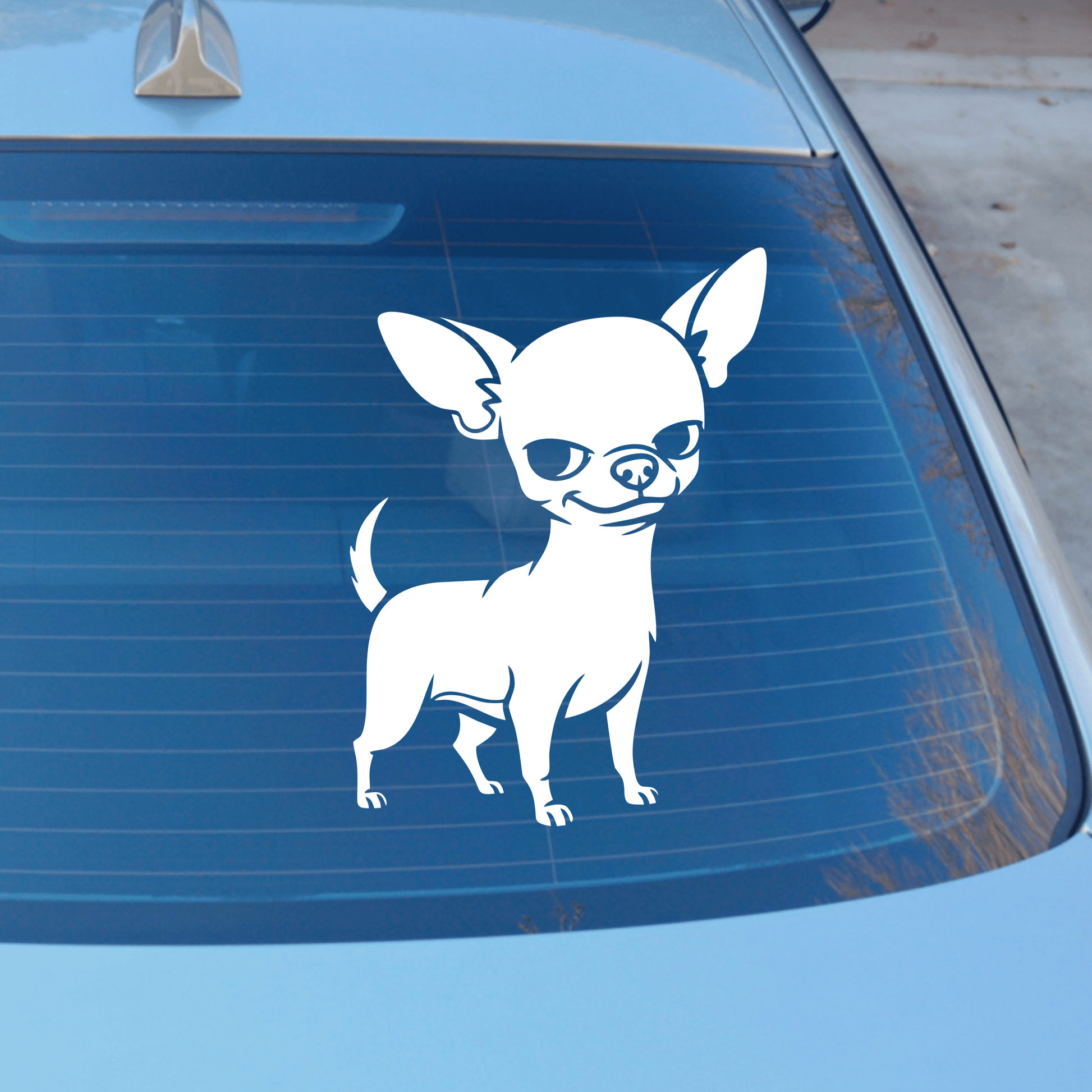White chihuahua decal on a blue car's rear window