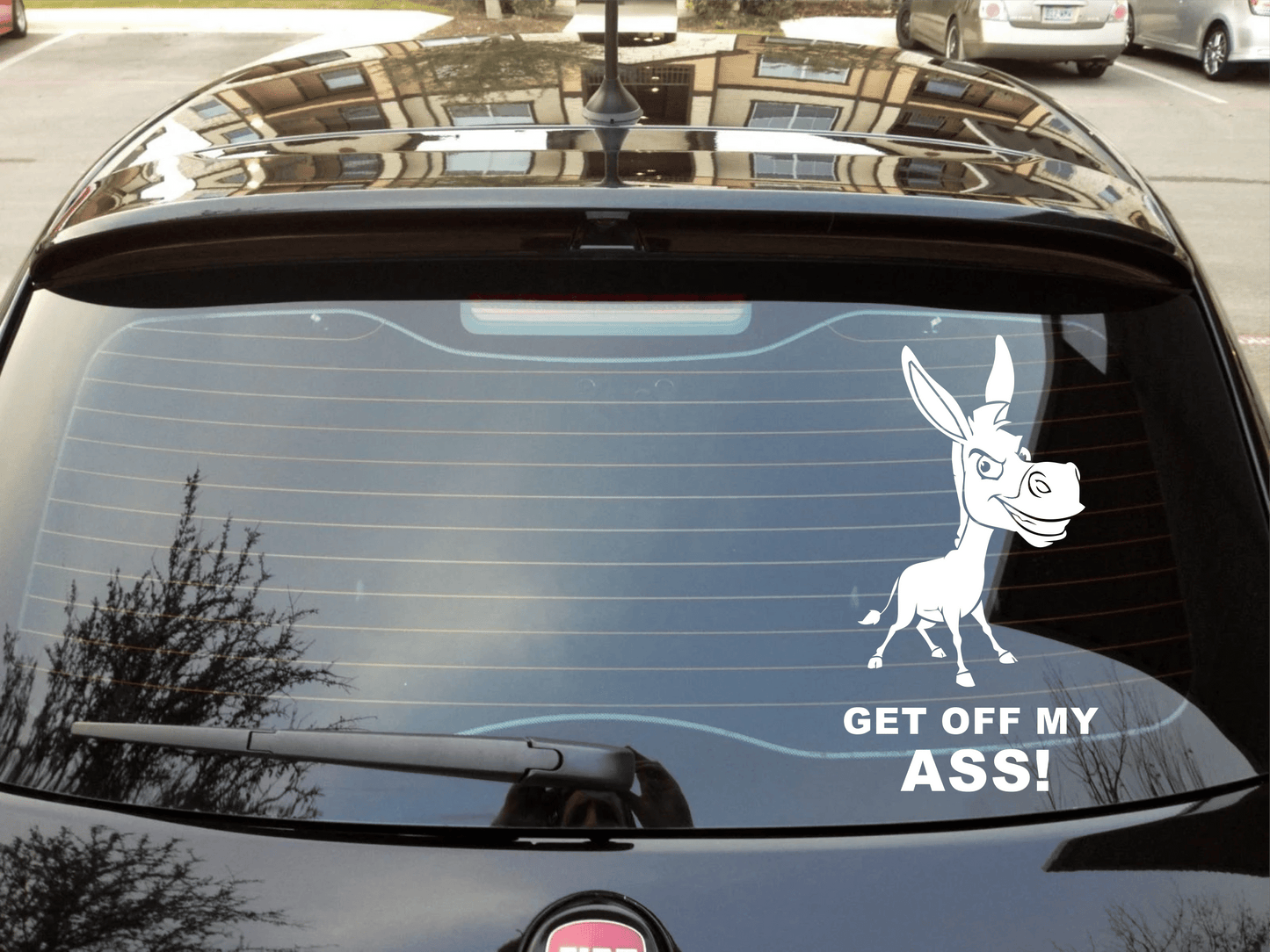 Car with a donkey decal and text 'GET OFF MY ASS!' on the windshield.