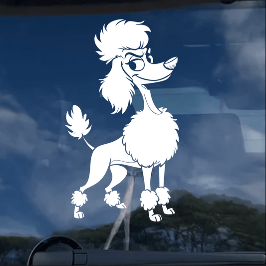 White poodle decal on a car window with a blue sky background