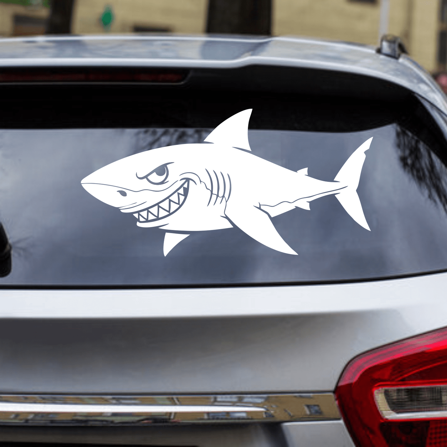 Shark decal on a car window with a blurred background