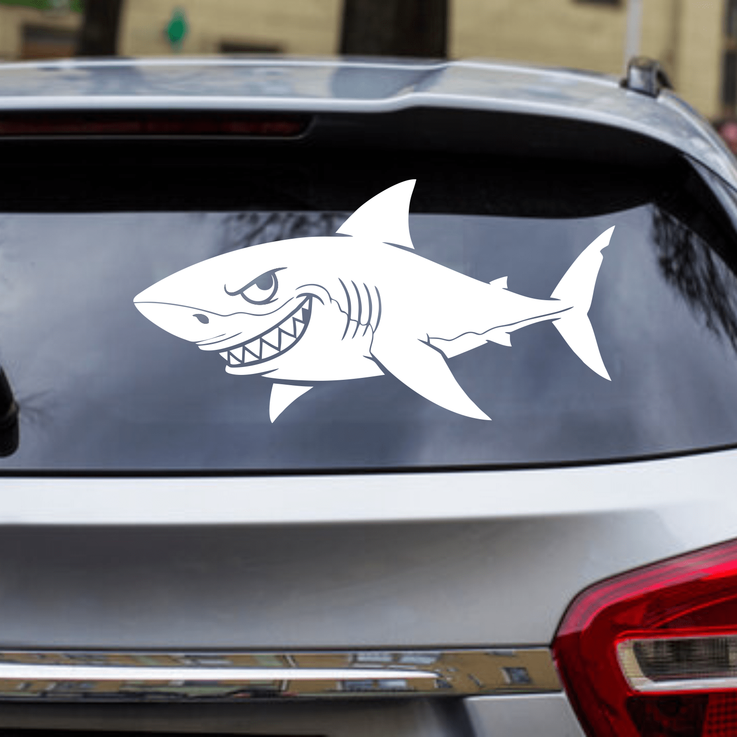 Shark decal on a car window with a blurred background