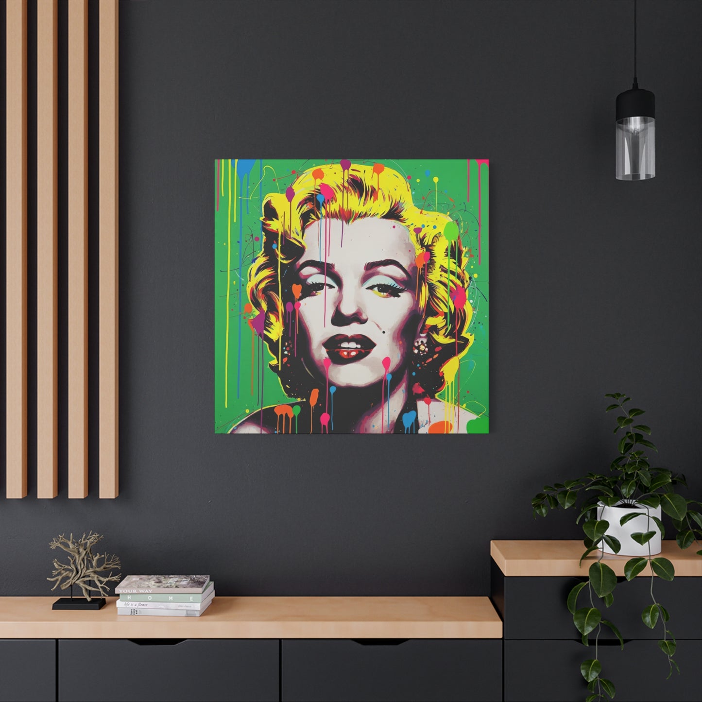 Colorful abstract portrait of a famous actress on a dark wall with a wooden shelf and plant.