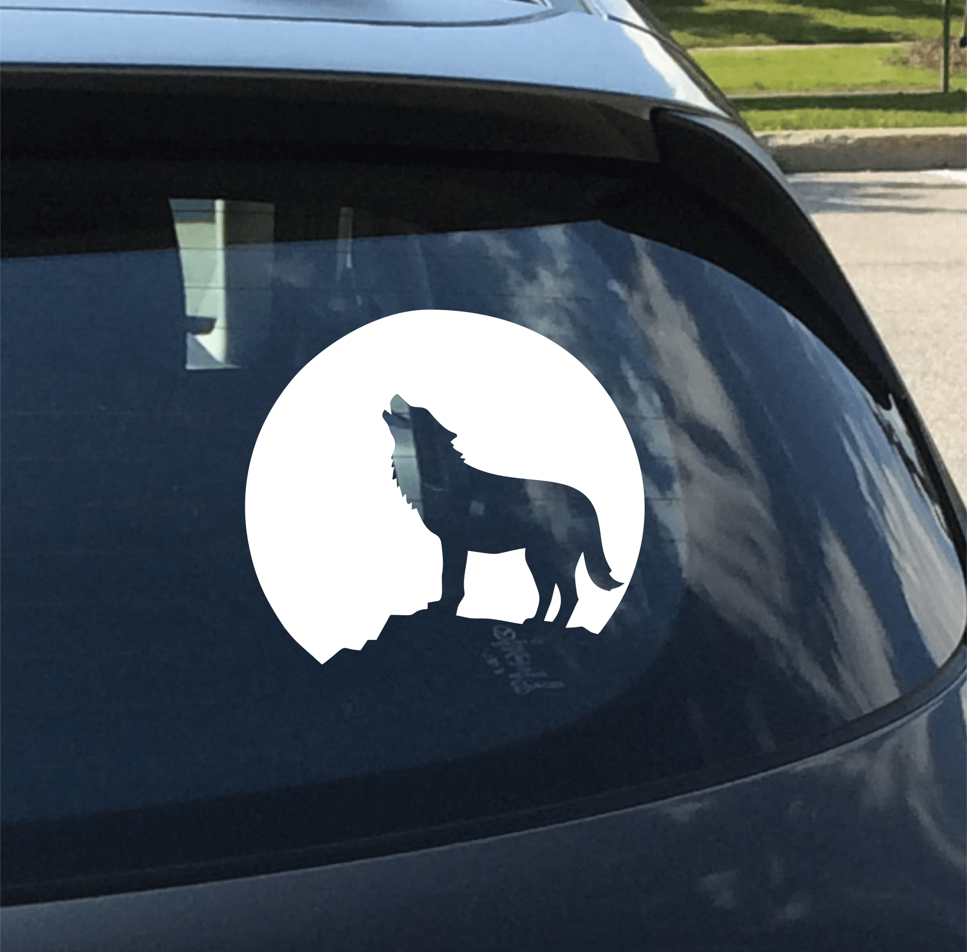 Wolf decal on a car window with a white circle background