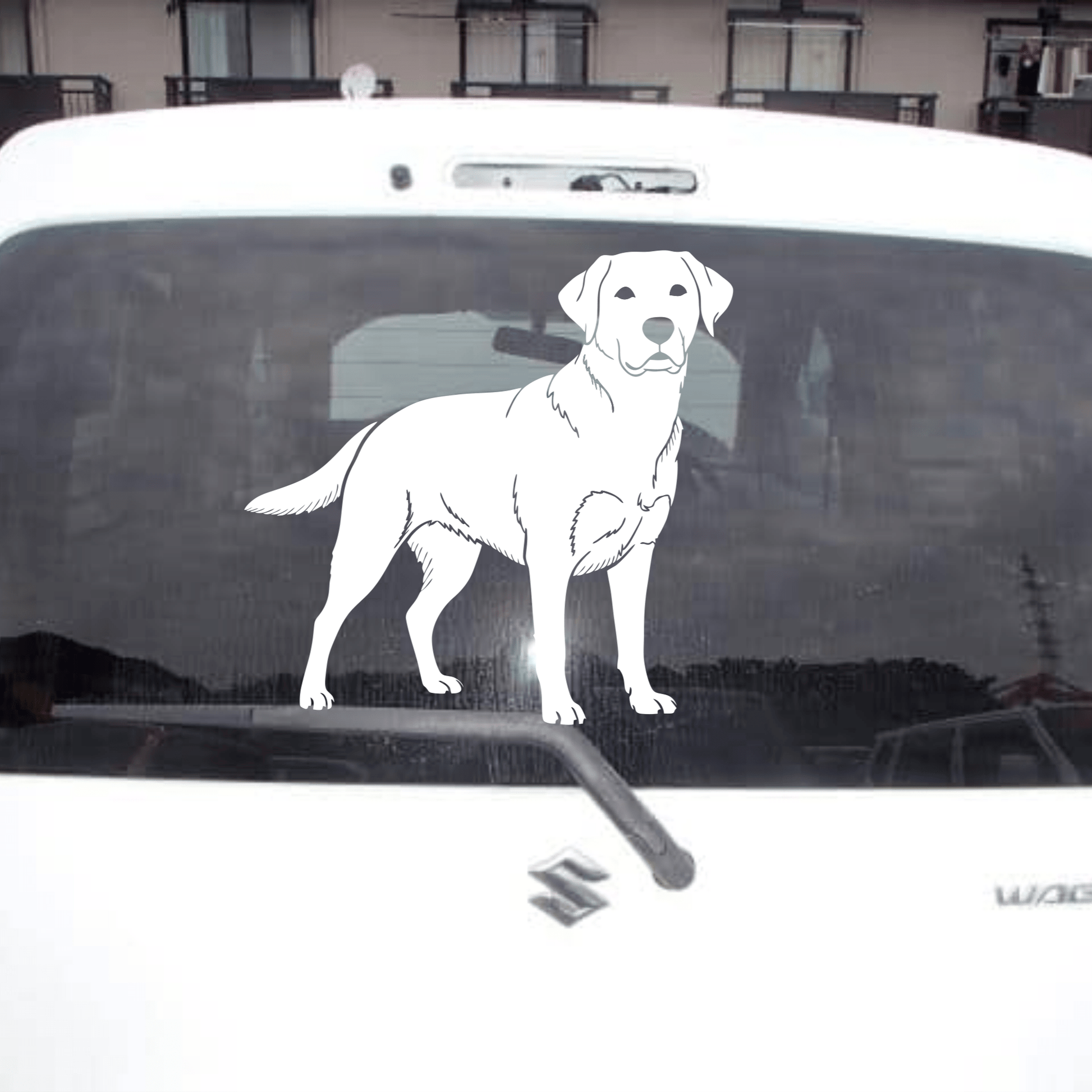 White Labrador decal on a car window with a building in the background