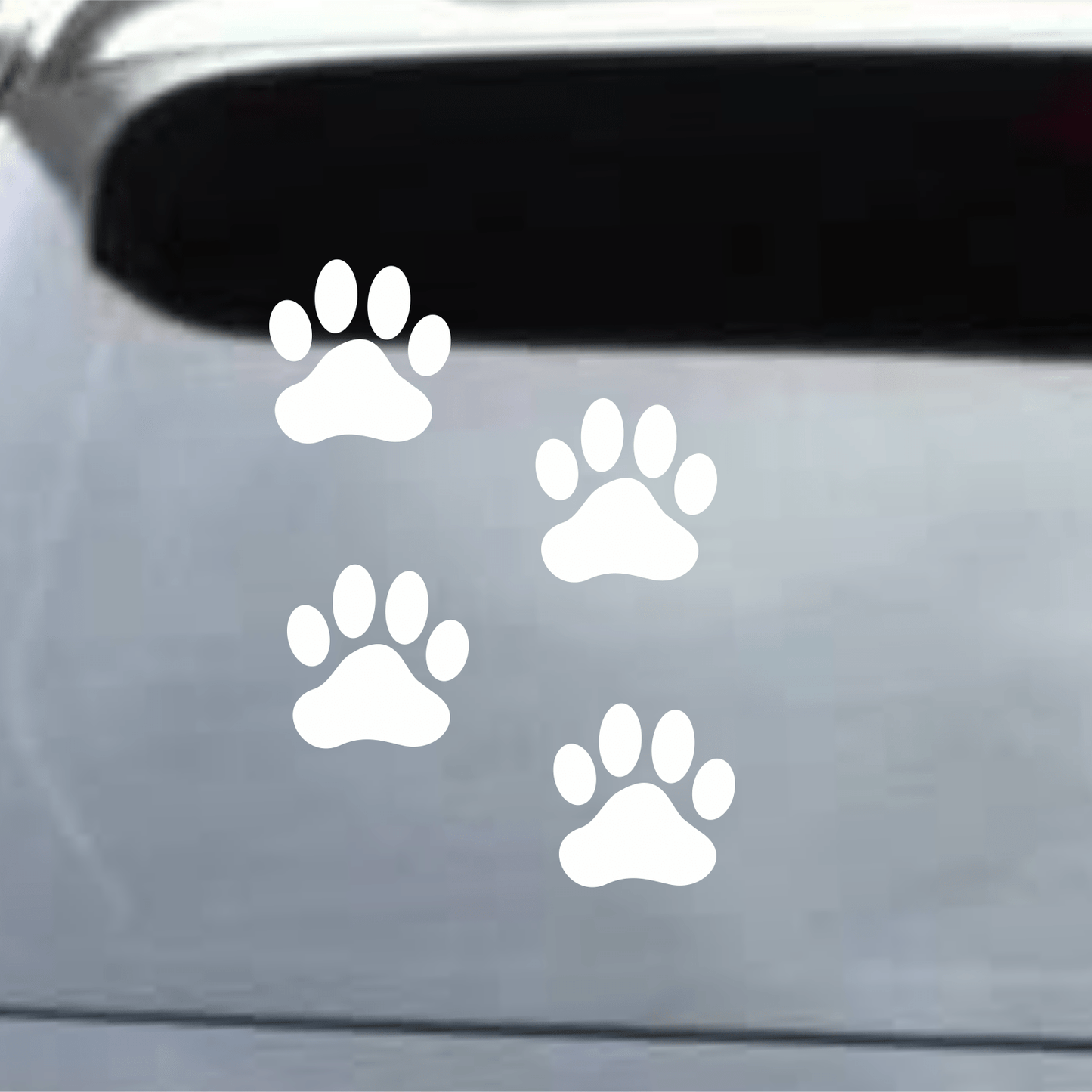 White paw print decals on a car window