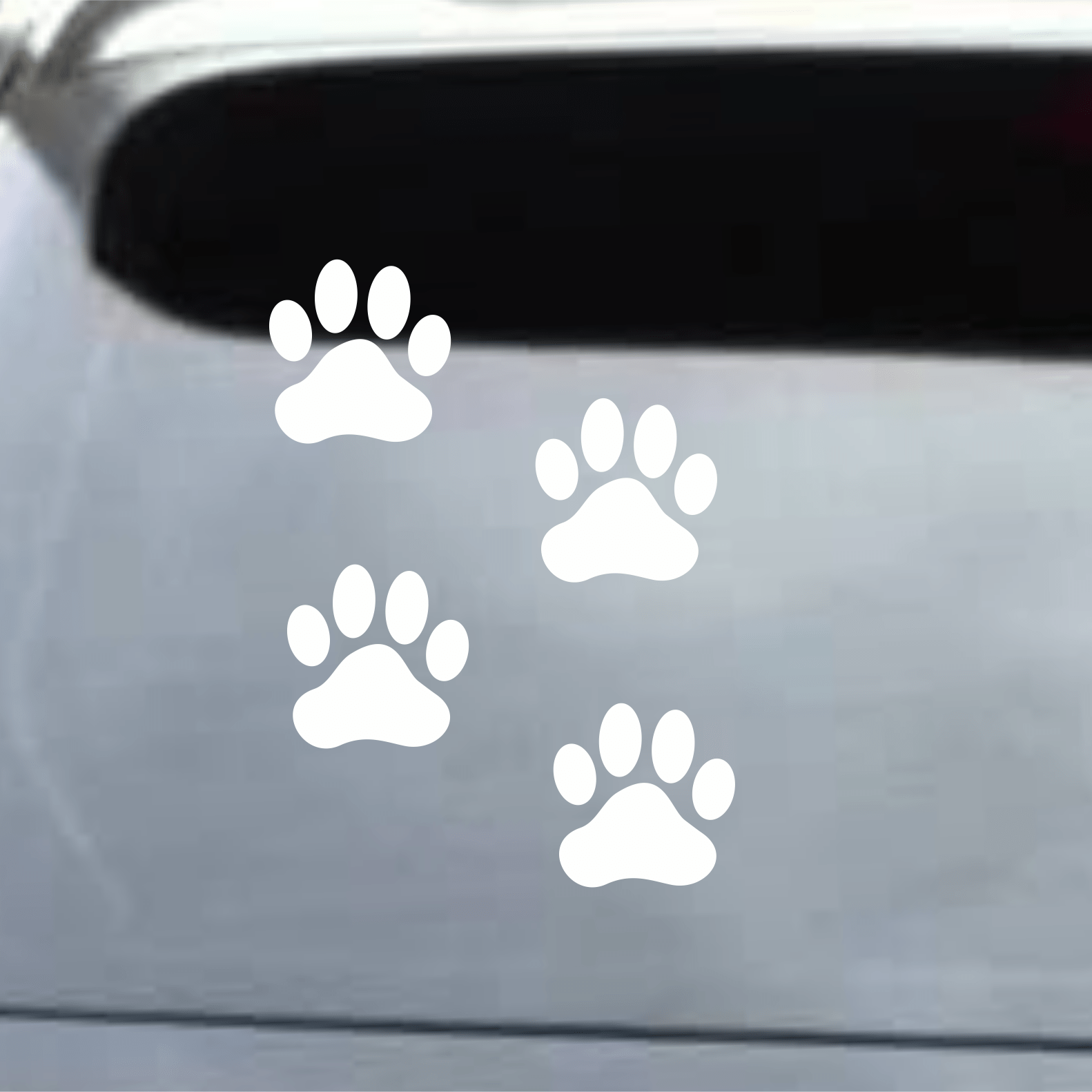 White paw print decals on a car window