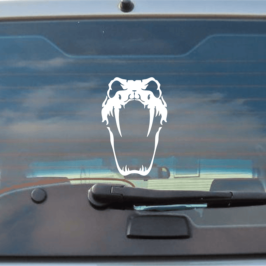 Car window with a white snake head decal against a blue sky.