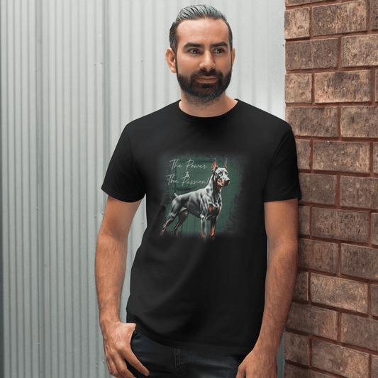 Man wearing a black t-shirt with a Doberman dog graphic and text, standing against a brick wall.