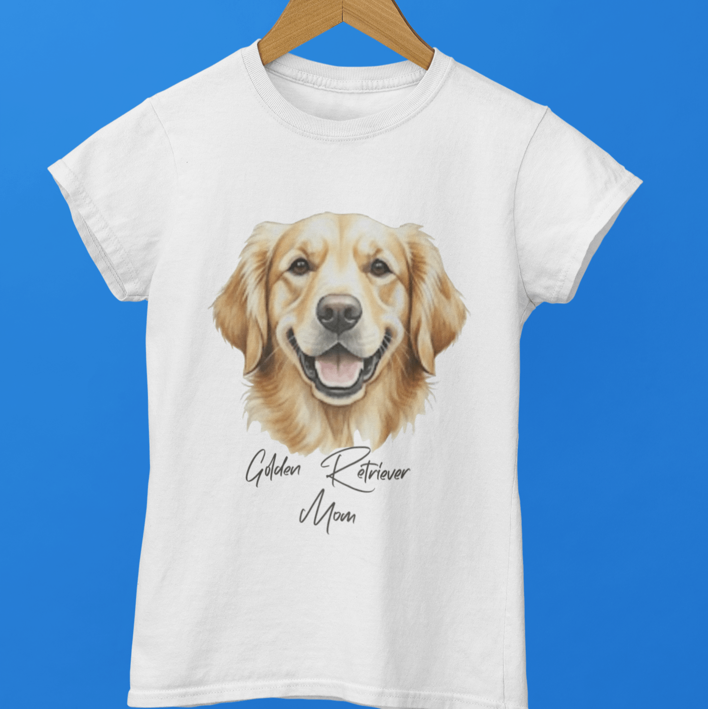 White t-shirt with a Golden Retriever graphic and text on a hanger against a blue background