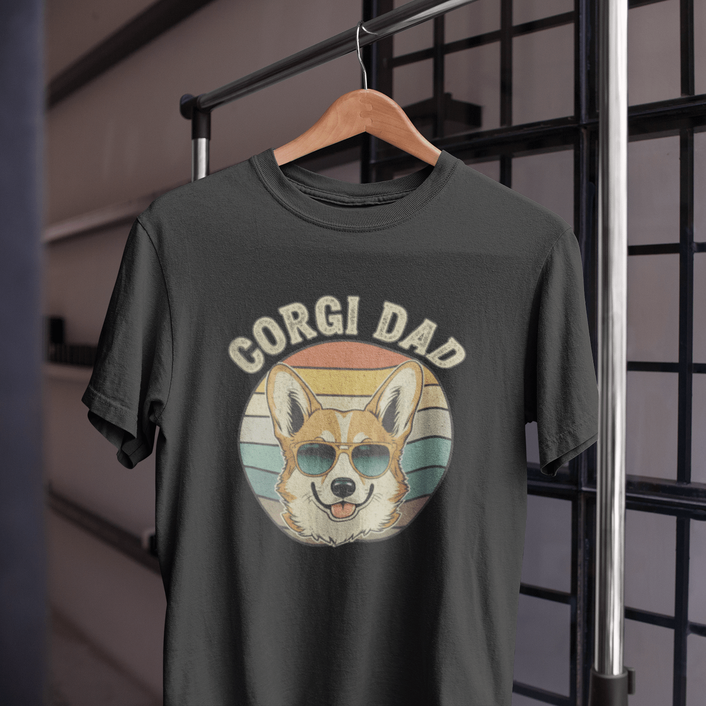 Black t-shirt with 'Corgi Dad' graphic on a hanger against a grid background