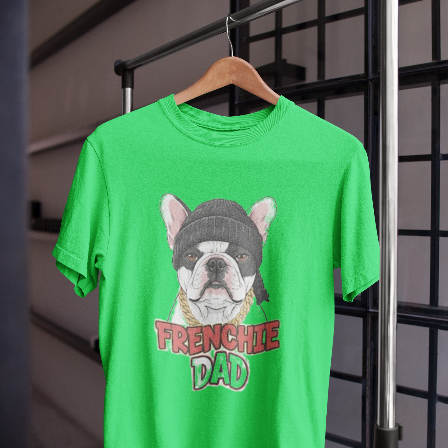 Green t-shirt with a dog graphic and 'FRENCHIE DAD' text on a hanger.