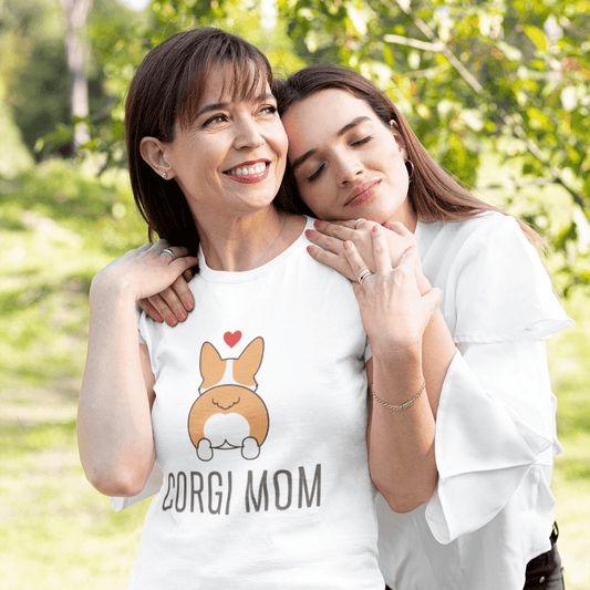 Two women standing outdoors with one wearing a 'Corgi Mom' t-shirt.
