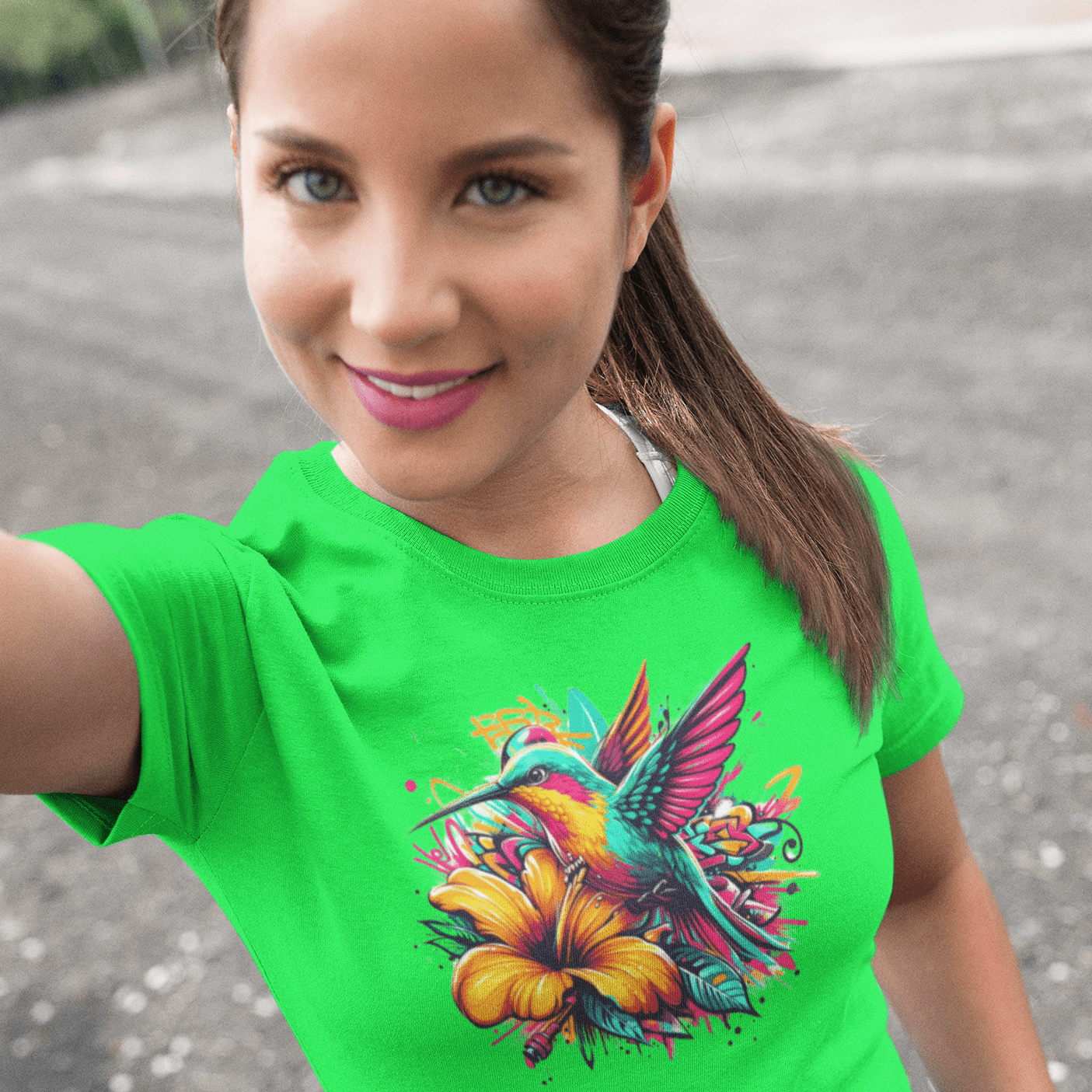 Graphic T-shirt featuring a colorful hummingbird surrounded by intricate floral designs, rendered in vibrant hues.