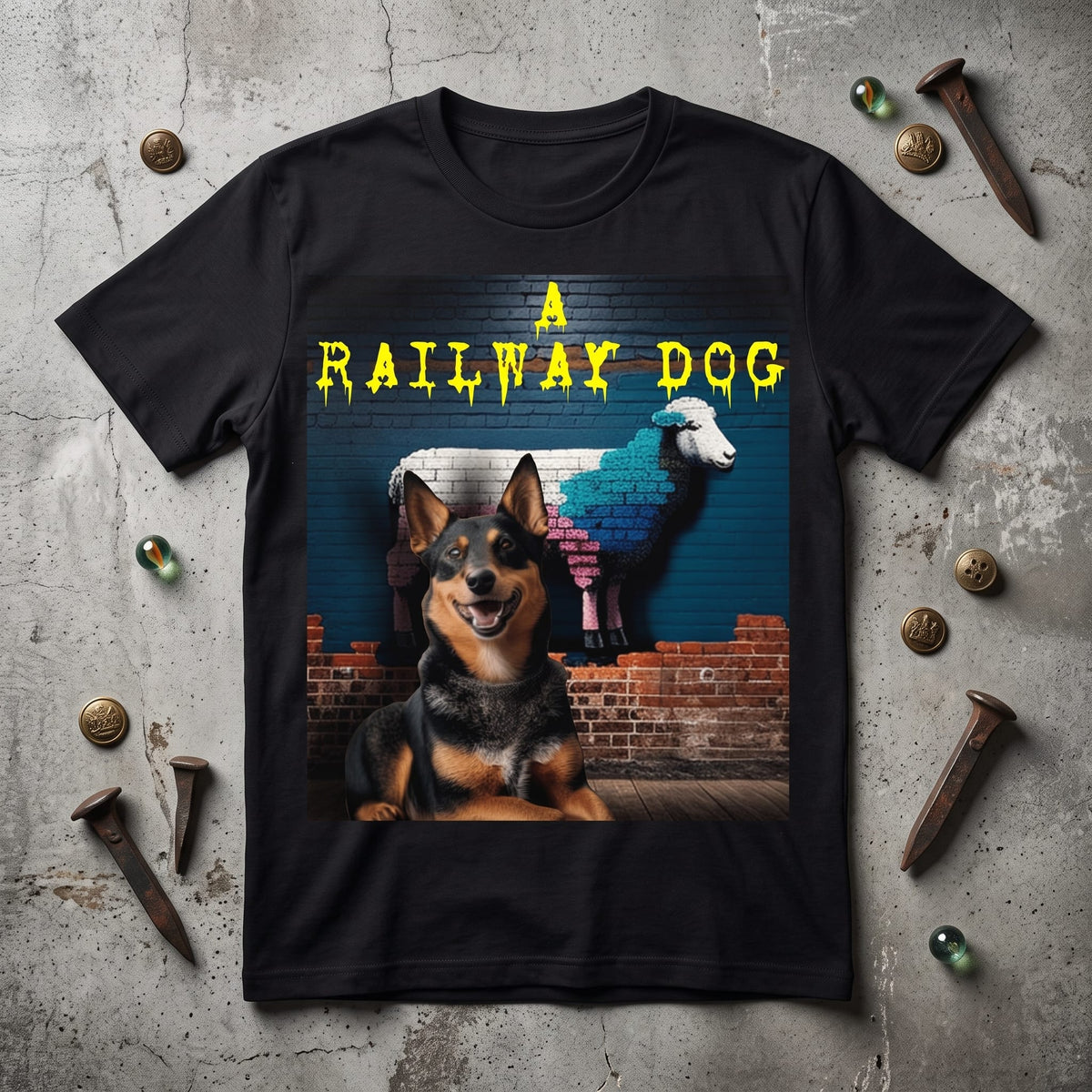 Black t-shirt with a vintage graphic print of an Australian Kelpie dog and a multi-colored brick sheep, laid on concrete