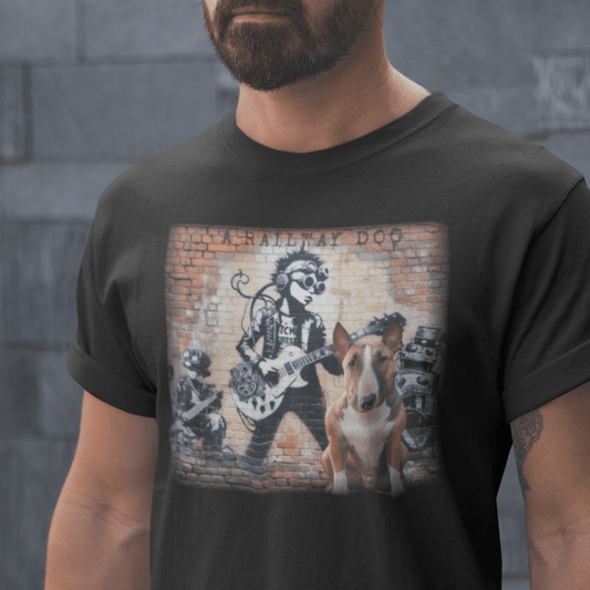 Close-up of a bearded man wearing a dark charcoal graphic t-shirt featuring an English Bull Terrier dog sitting in front of a brick wall mural with steampunk rock musicians and "A Railway Dog" stencil text.