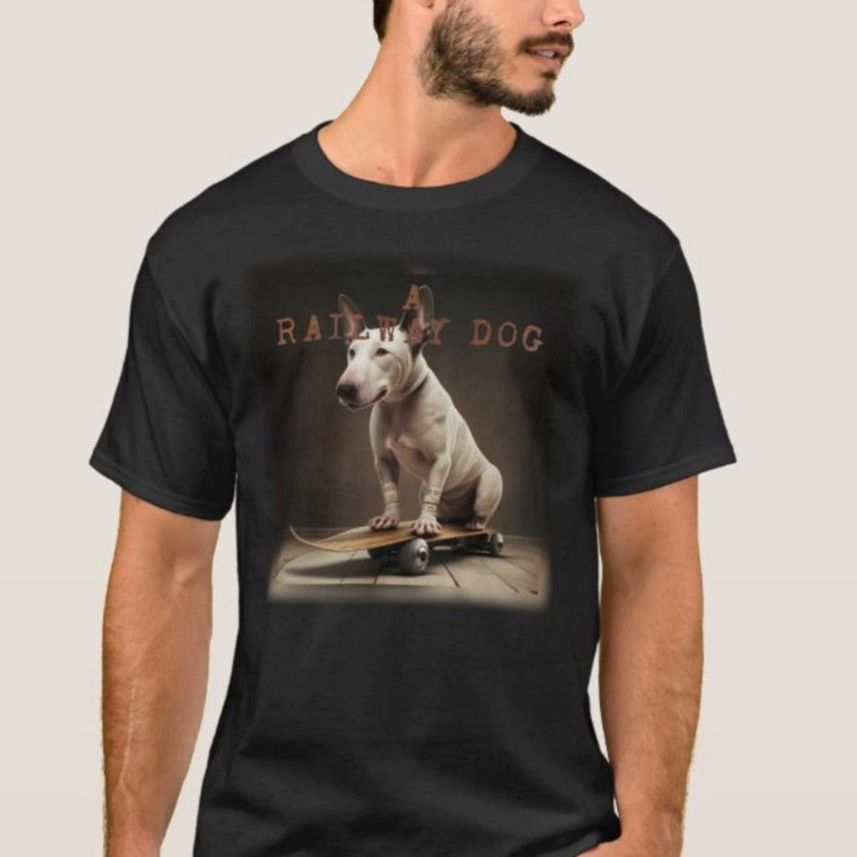 Man with a beard wearing a black graphic t-shirt featuring a white English Bull Terrier sitting on a vintage wooden skateboard with "A Railway Dog" stencil text above.