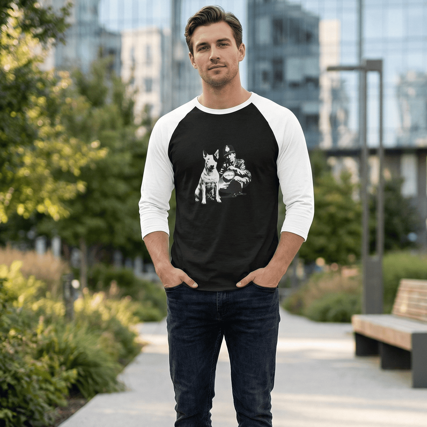 A man in a black and white baseball shirt with a bull terrier and police officer design stands outside.