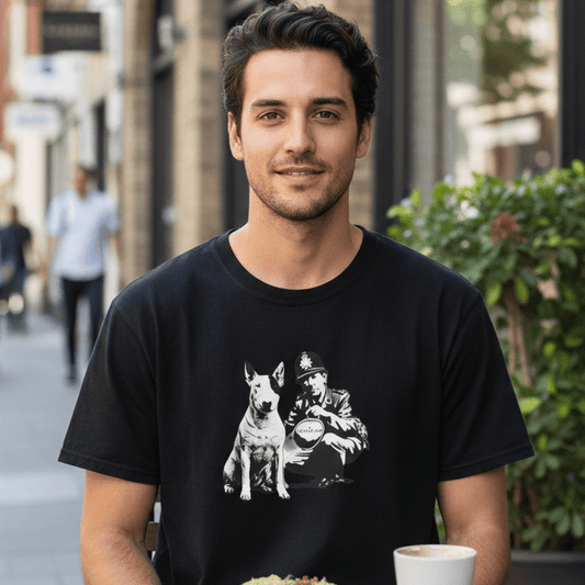 Man wearing black dog lover graphic T-shirt with vintage dog and officer design, sitting at an outdoor café