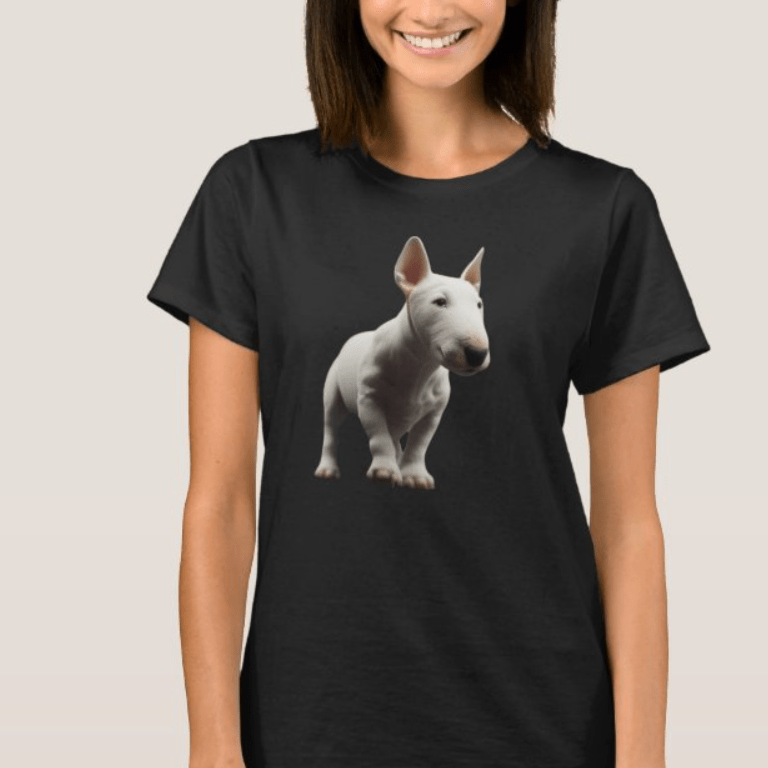 Smiling woman wearing a black graphic t-shirt featuring a clean, realistic cutout illustration of a white English Bull Terrier puppy standing forward on a solid black background.