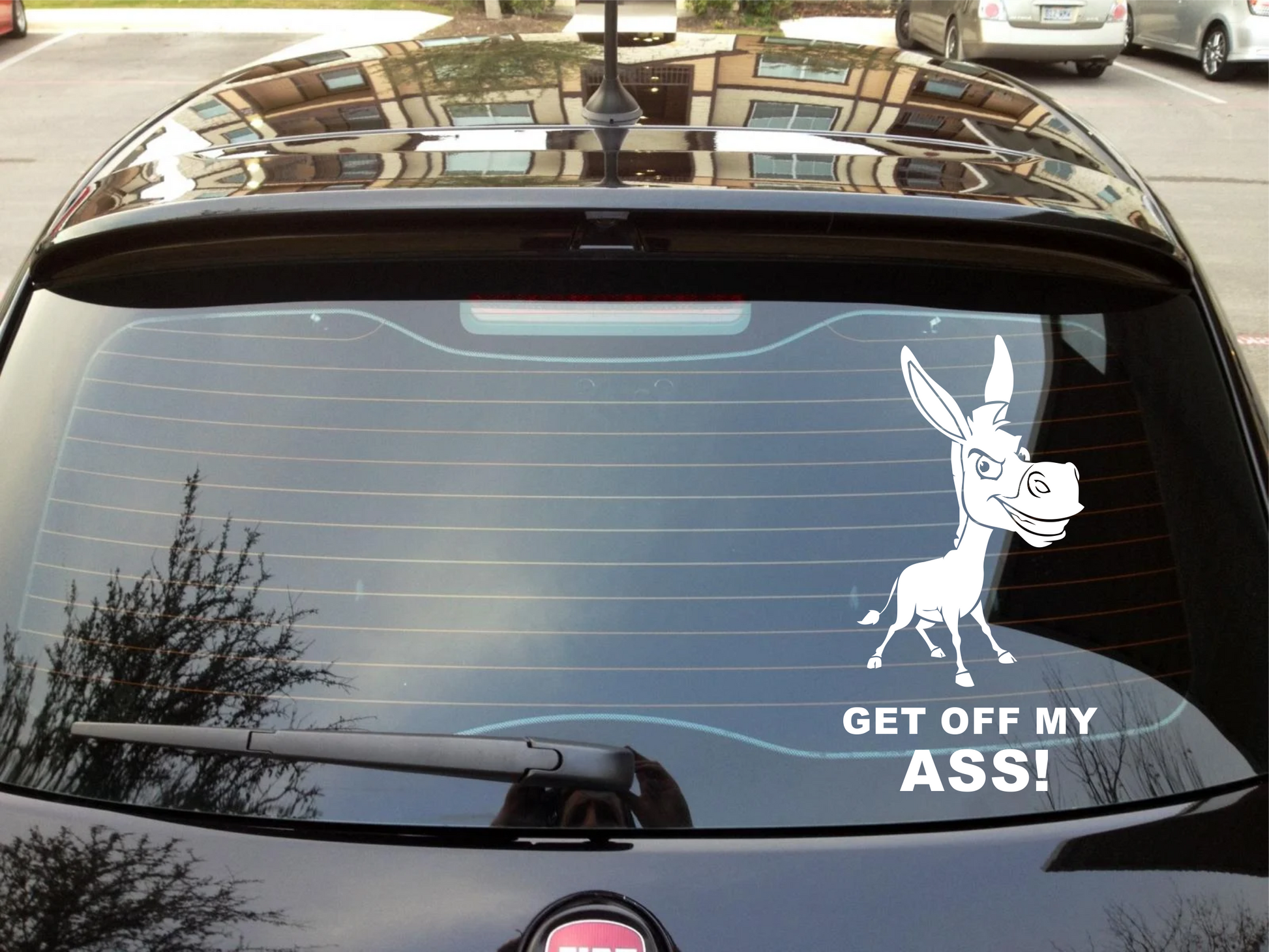 Car with a donkey decal and text 'GET OFF MY ASS!' on the windshield.