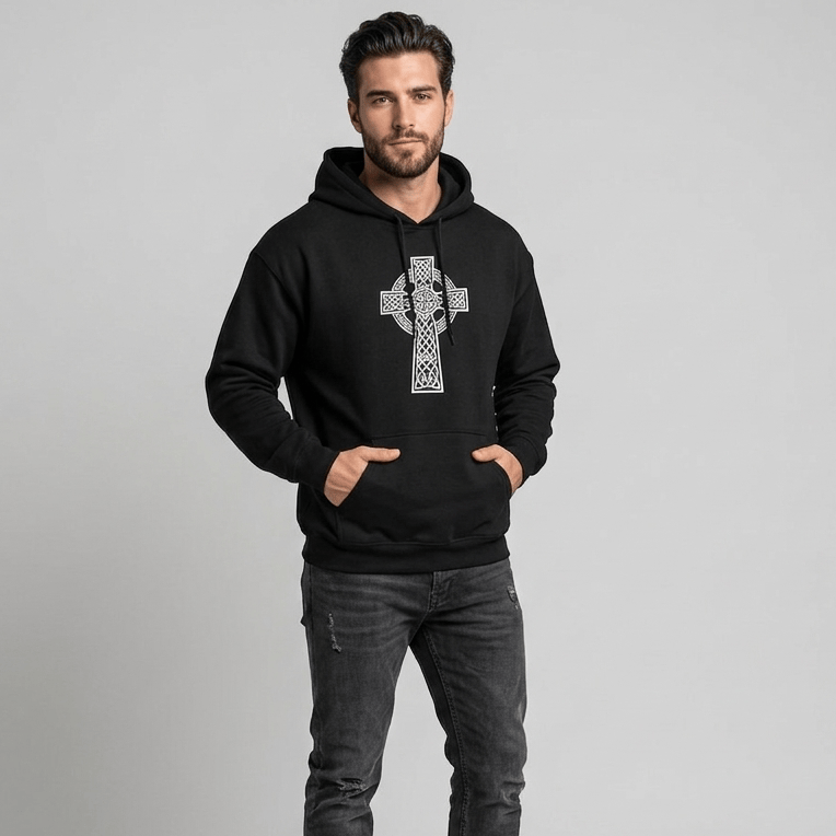 Man wearing a black hoodie with a white cross design on a gray background