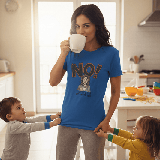 Woman in a kitchen wearing a blue t-shirt with 'NO!' text, holding a mug.