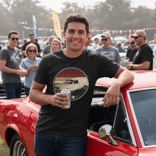 Man standing wearing an EH Holden t-shirt holding a can, with a crowd and cars in the background