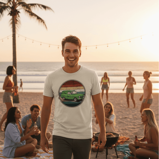 Man on a beach wearing a white t-shirt with a colorful Escort Panel Van design, surrounded by people enjoying a sunset.
