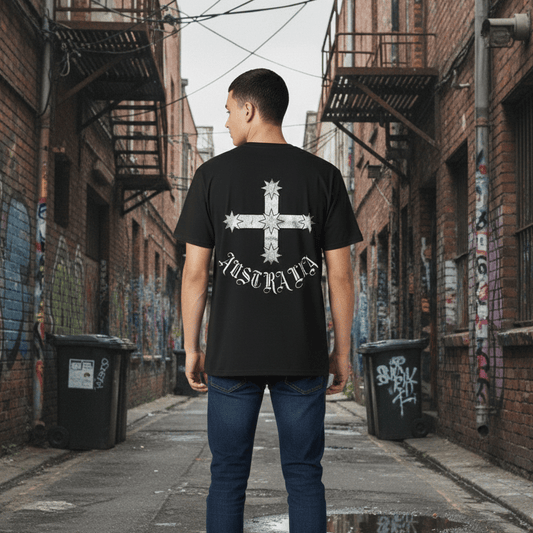 Person wearing a black t-shirt with a white Eureka Flag graphic design in an alleyway with graffiti.