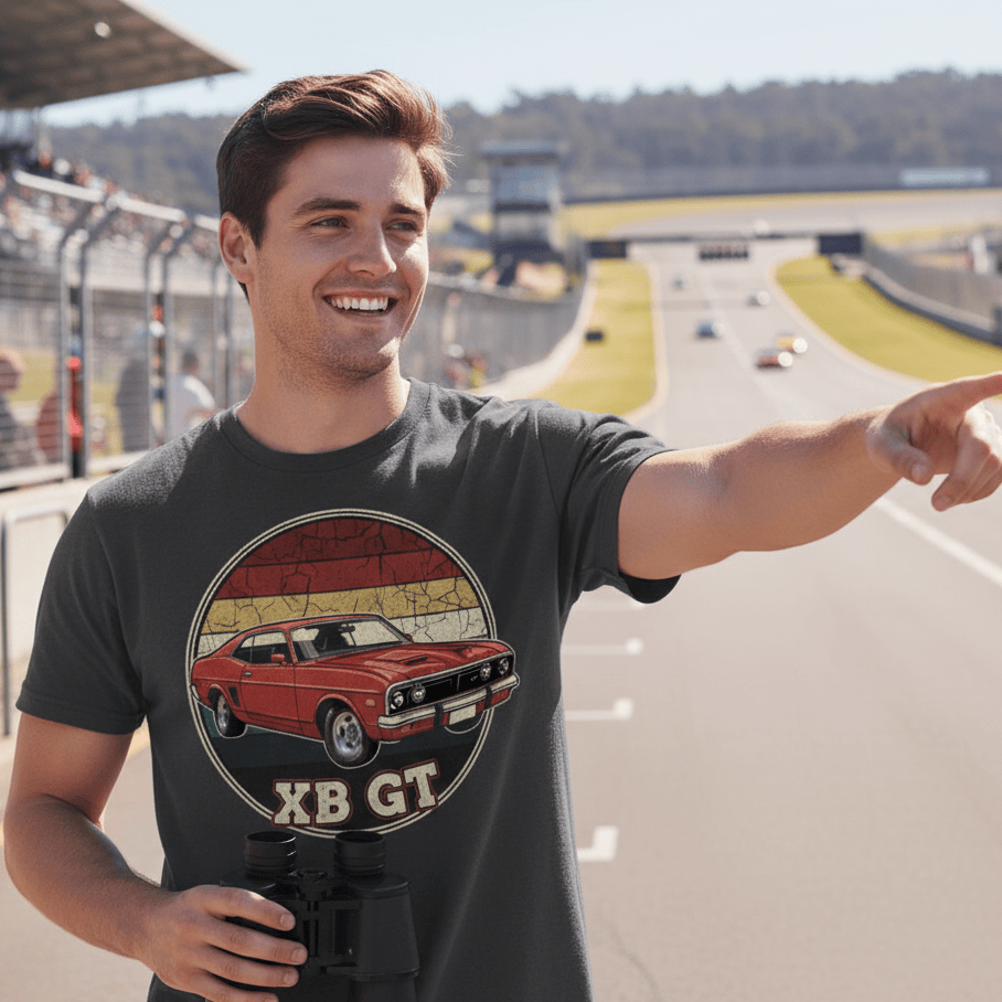Man wearing a Ford XB GT t-shirt with a car design, pointing towards a race track.