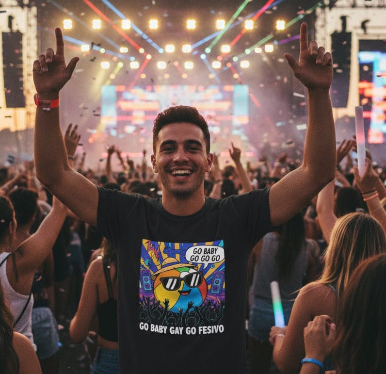 Man at a music festival with arms raised, wearing a “Go Baby Go Go” colorful t-shirt.