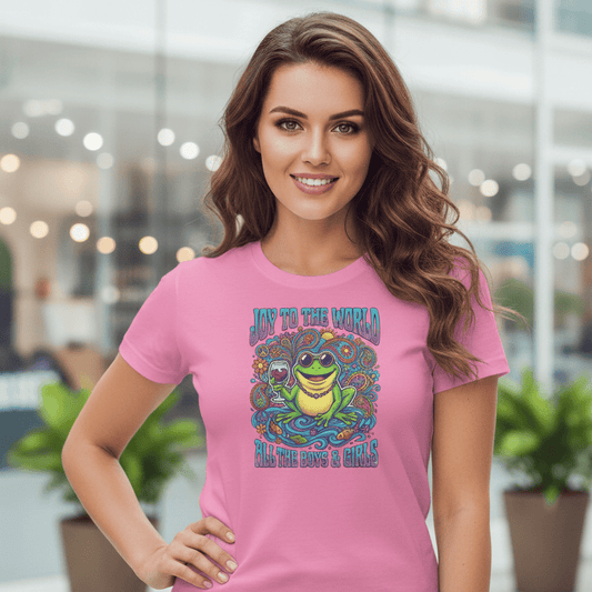 Woman wearing a pink t-shirt with a colorful frog graphic design in an indoor setting.