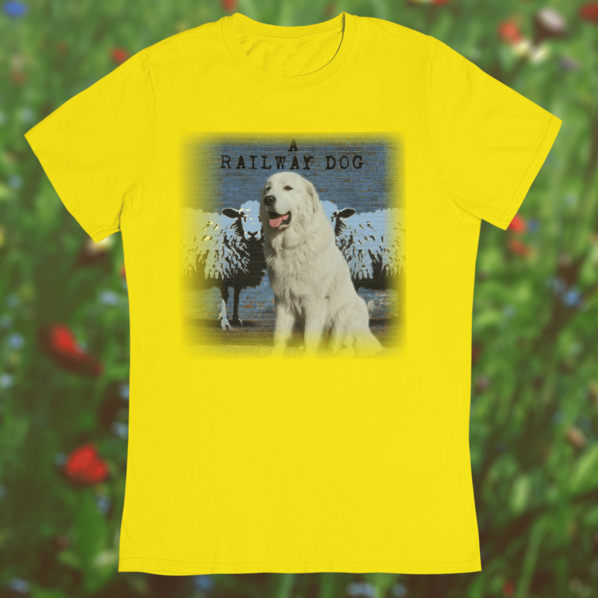graphic t-shirt featuring a white Maremma dog sitting in front of stenciled sheep and a blue brick wall with "A Railway Dog" text.