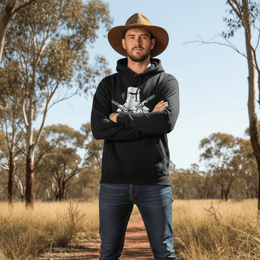 He is wearing a black hoodie featuring a white graphic of a Ned Kelly-style iron helmet with two crossed pistols.