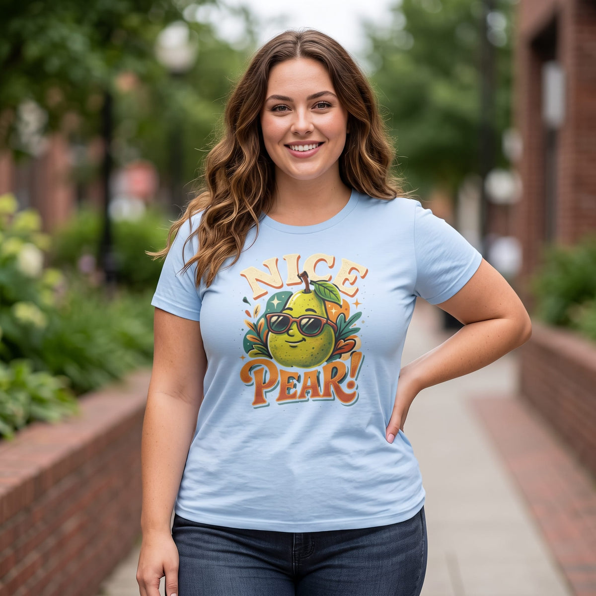 Smiling woman wearing fitted light blue Nice Pear retro fruit pun t-shirt outdoors