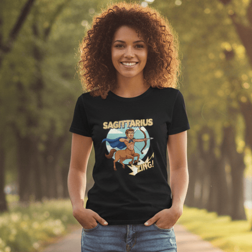 A custom Sagittarius zodiac superhero graphic featuring a centaur hero with a blue cape drawing a bow and arrow. The design uses retro comic book typography with the words 'SAGITTARIUS' and 'ZING!' set against a circular sky background, ideal for t-shirt printing.