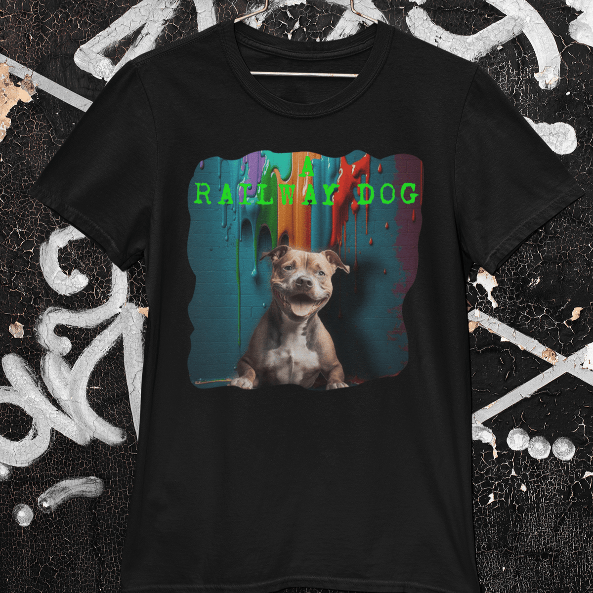Black graphic t-shirt featuring a smiling staffy dog under vibrant dripping street art paint with green text reading "A Railway Dog