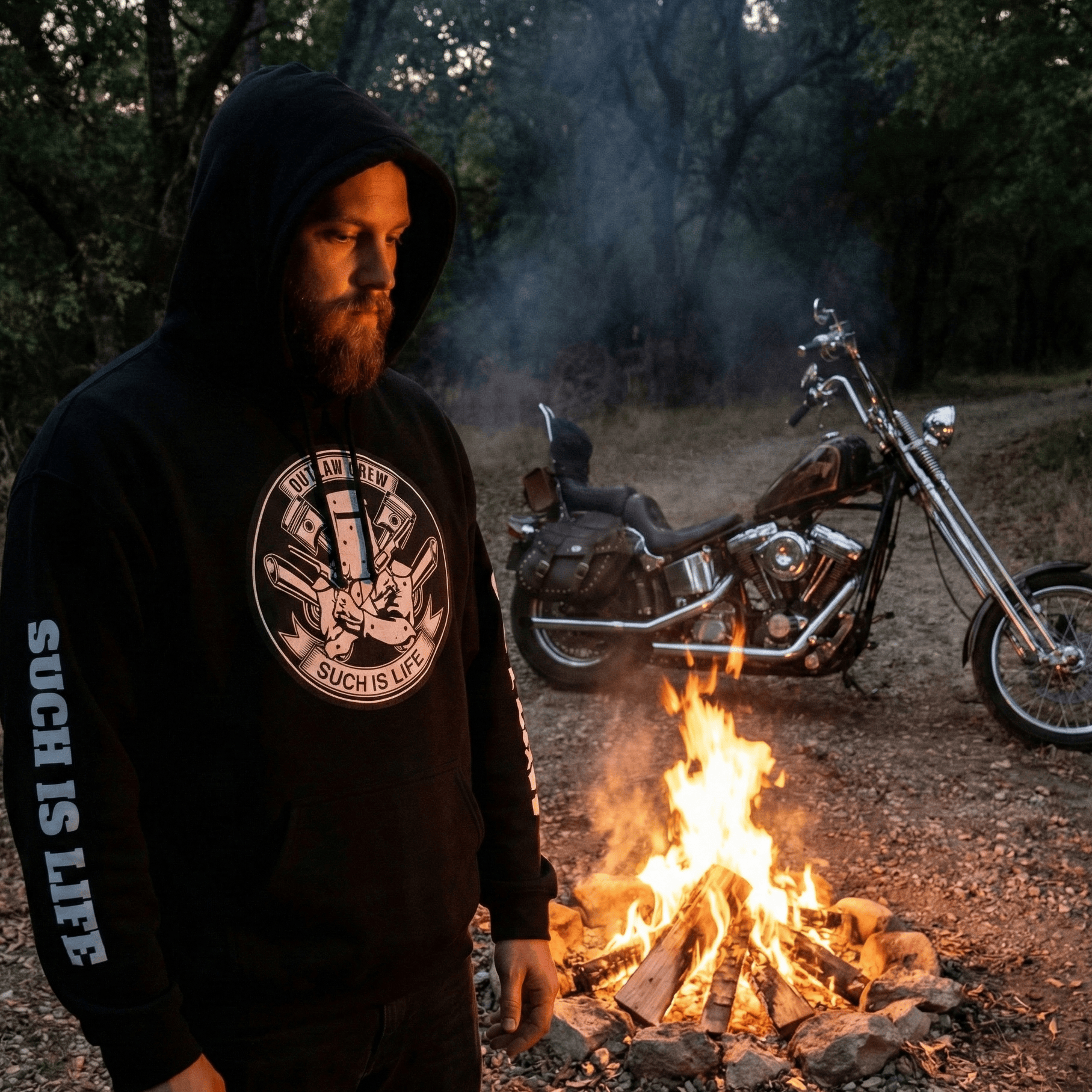 Black pullover hoodie featuring a white circular graphic in the center. The graphic depicts the Ned Kelly iron helmet crossed with engine pistons, surrounded by text "Outlaw Crew" and "Such Is Life." The hoodie features bold white vertical text on the sleeves reading "SUCH IS LIFE" on one arm and "OUTLAW" on the other.
