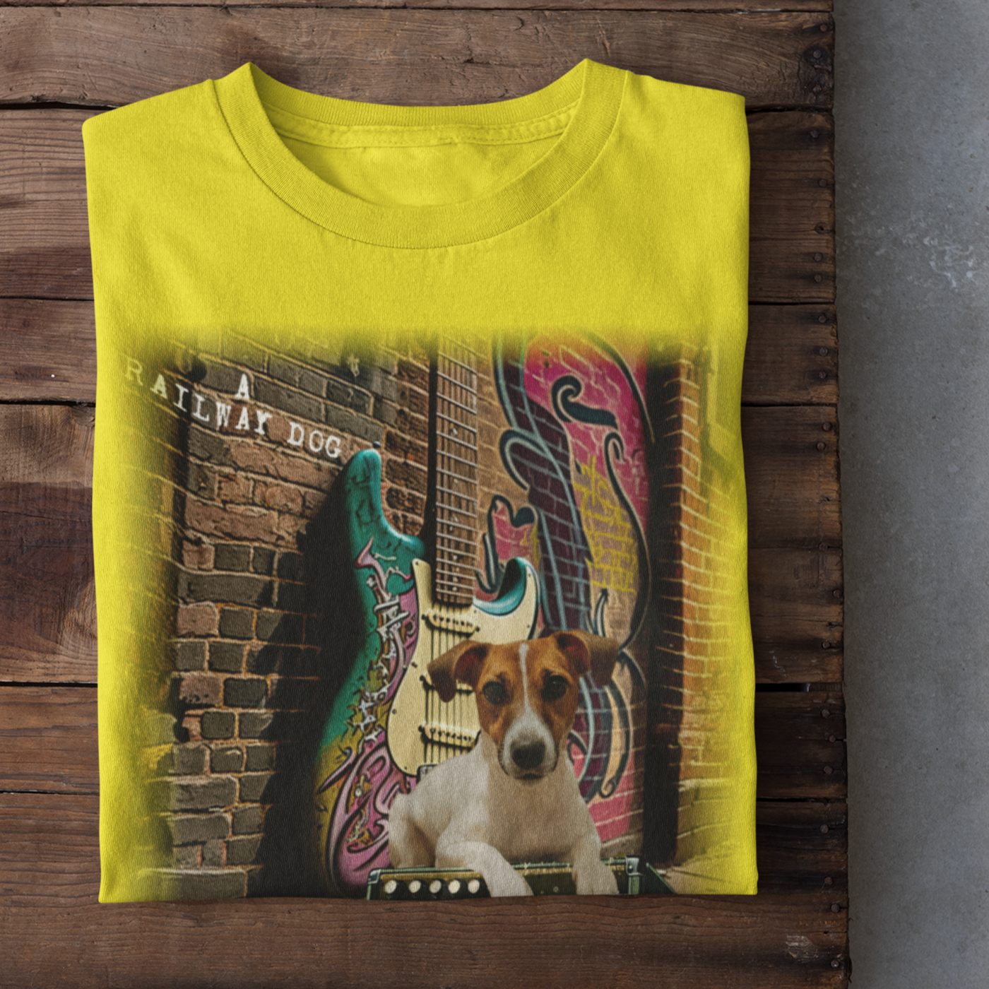 This t-shirt combines a Jack Russell Terrier dog with a classic Fender Stratocaster electric guitar in a graphic image.