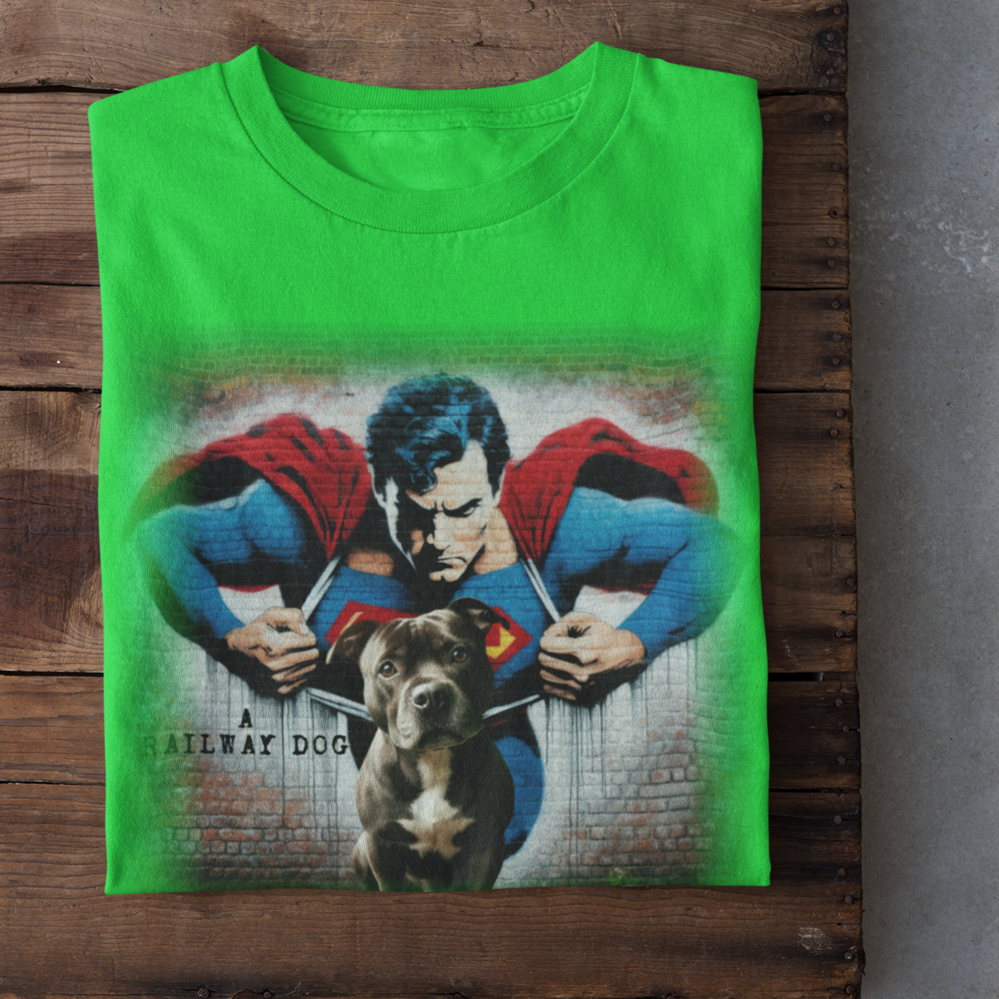 Graphic T-shirt featuring a playful Staffordshire Bull Terrier in a Superman costume, with a bold and colorful comic book style design.