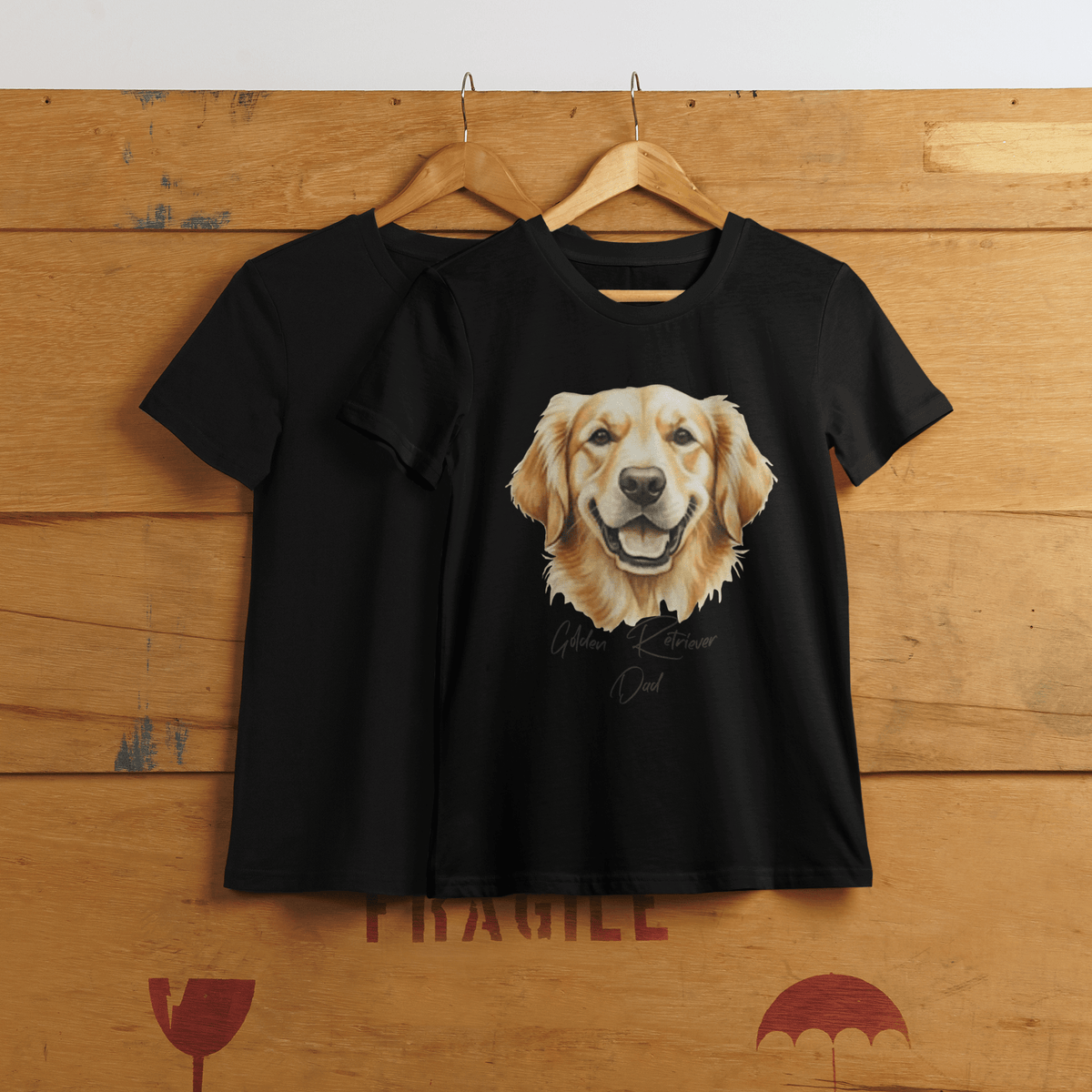 Black t-shirt with Golden Retriever graphic on a wooden surface