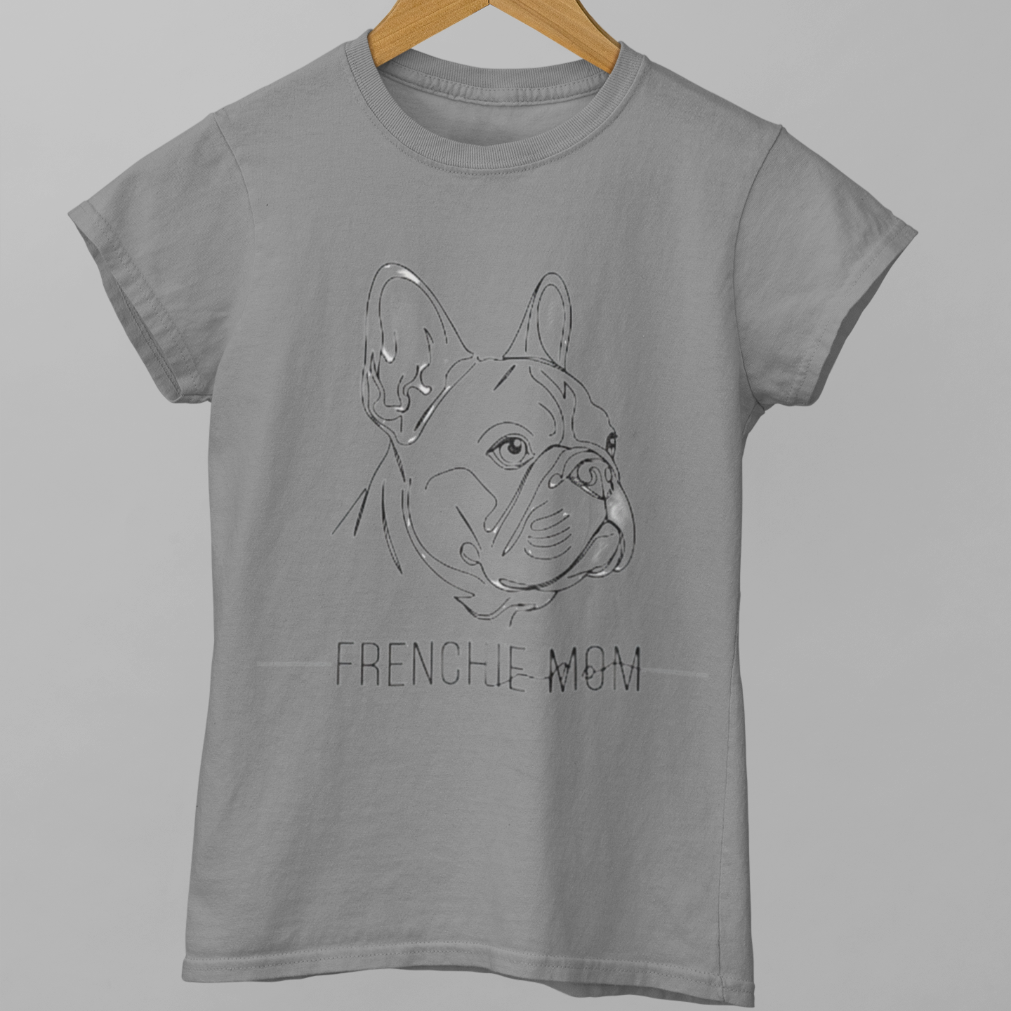 Gray t-shirt with a French Bulldog graphic and 'FRENCHIE MOM' text on a hanger against a gray background