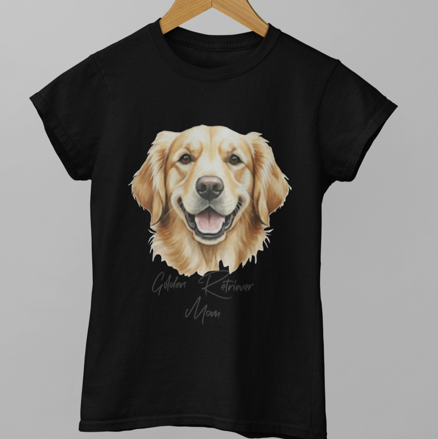 Black t-shirt with a golden retriever graphic on a hanger against a gray background