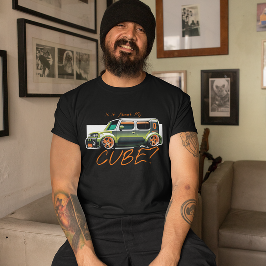 Man wearing a black t-shirt with a graphic design sitting in a room with framed pictures on the wall.
