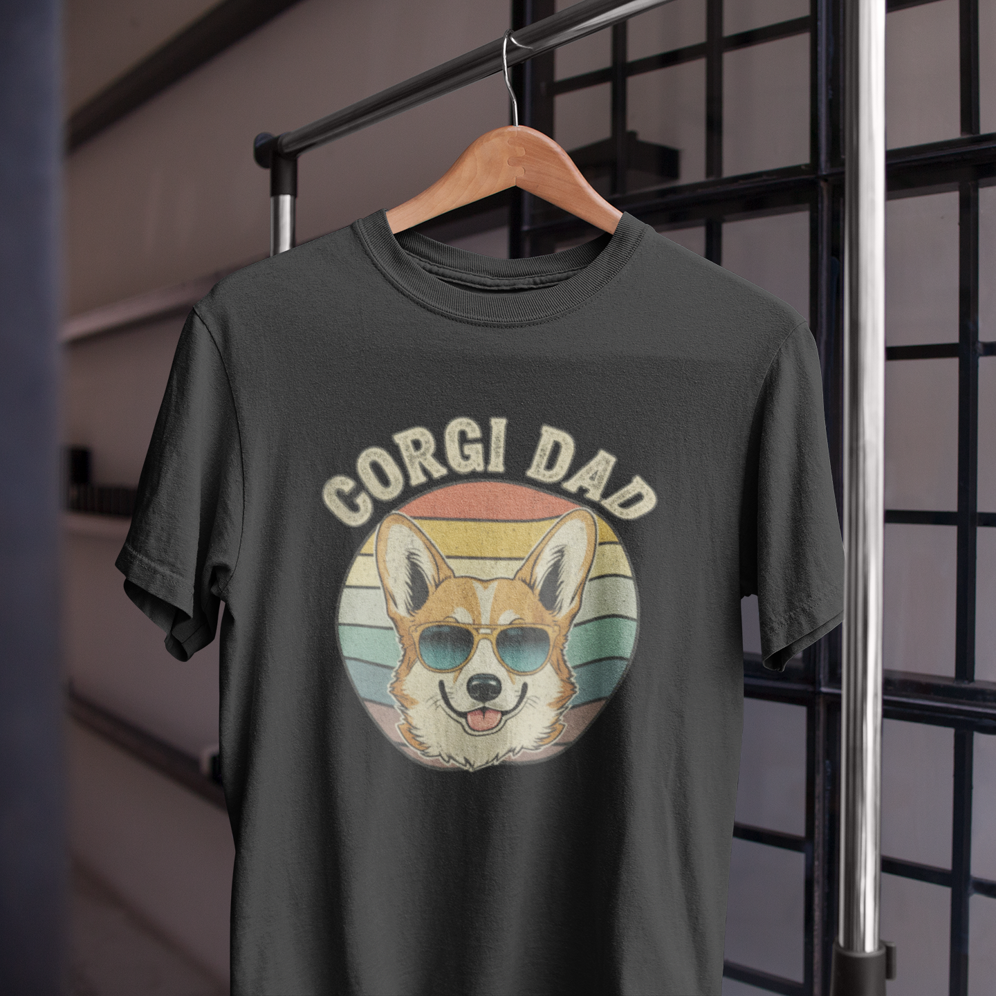 Black t-shirt with 'Corgi Dad' graphic on a hanger against a grid background