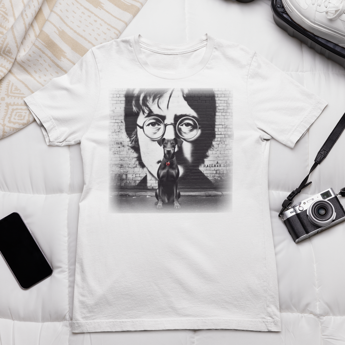 Graphic T-shirt featuring a Manchester Terrier in tribute to John Lennon, with a stylish and artistic design inspired by the iconic musician.