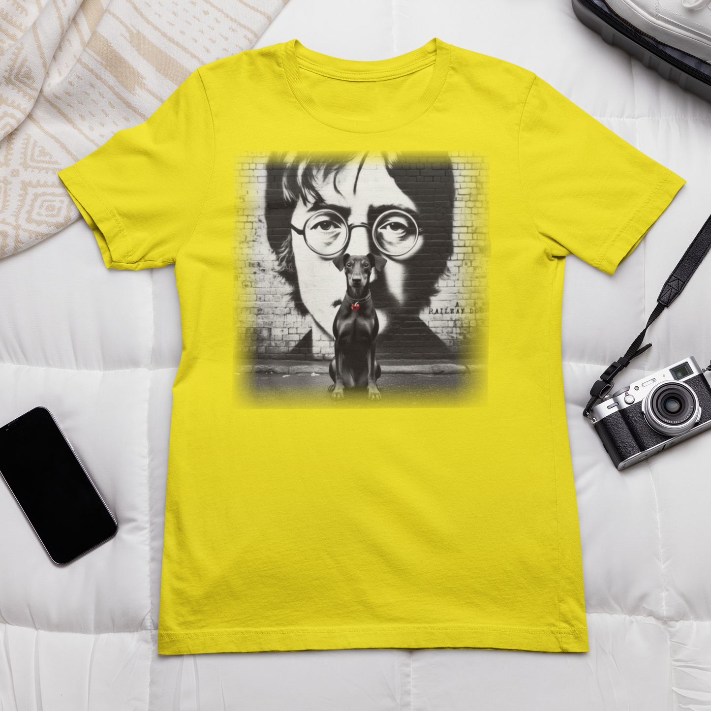 Graphic T-shirt featuring a Manchester Terrier in tribute to John Lennon, with a stylish and artistic design inspired by the iconic musician.