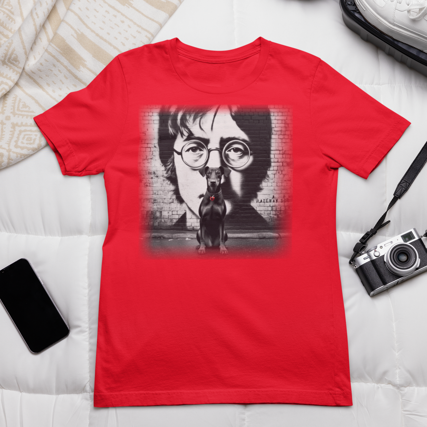 Graphic T-shirt featuring a Manchester Terrier in tribute to John Lennon, with a stylish and artistic design inspired by the iconic musician.