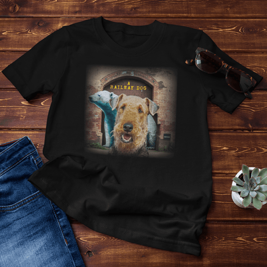 graphic t-shirt flat lay featuring an Airedale Terrier in front of a brick tunnel with a painted bear mural and "A Railway Dog" text.
